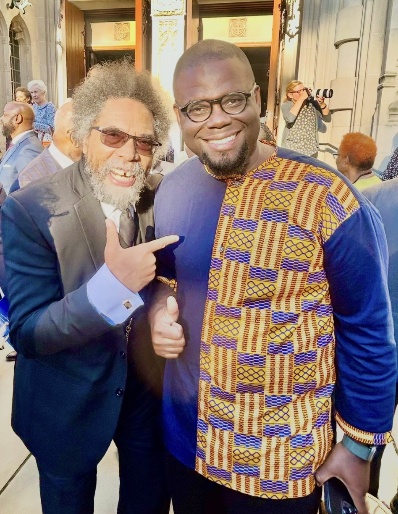 Jeremy Q. Henry standing with Dr. Cornel West outside a historic building